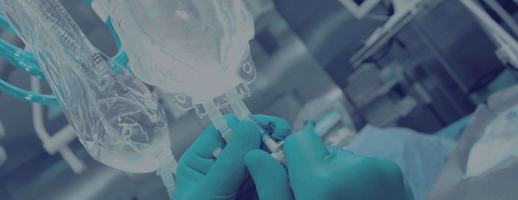 latex gloved hands adjusting IV bag