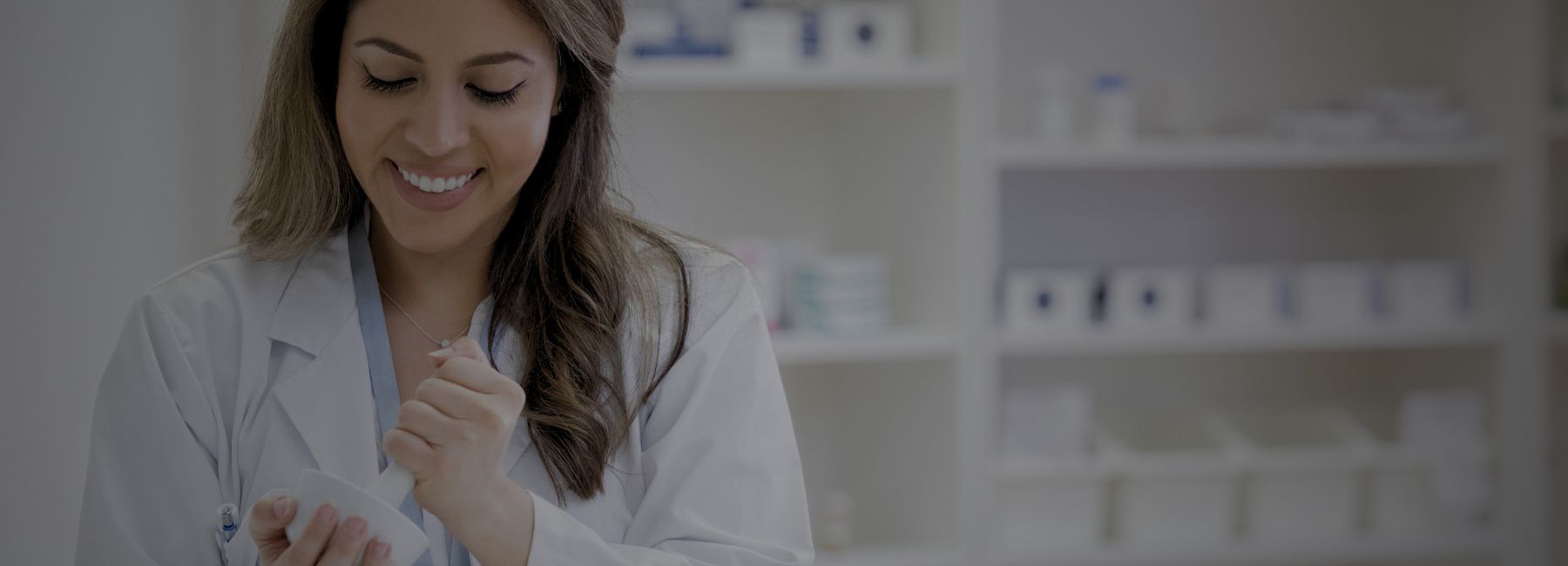 pharmacy student in lab coat with mortar and pestle