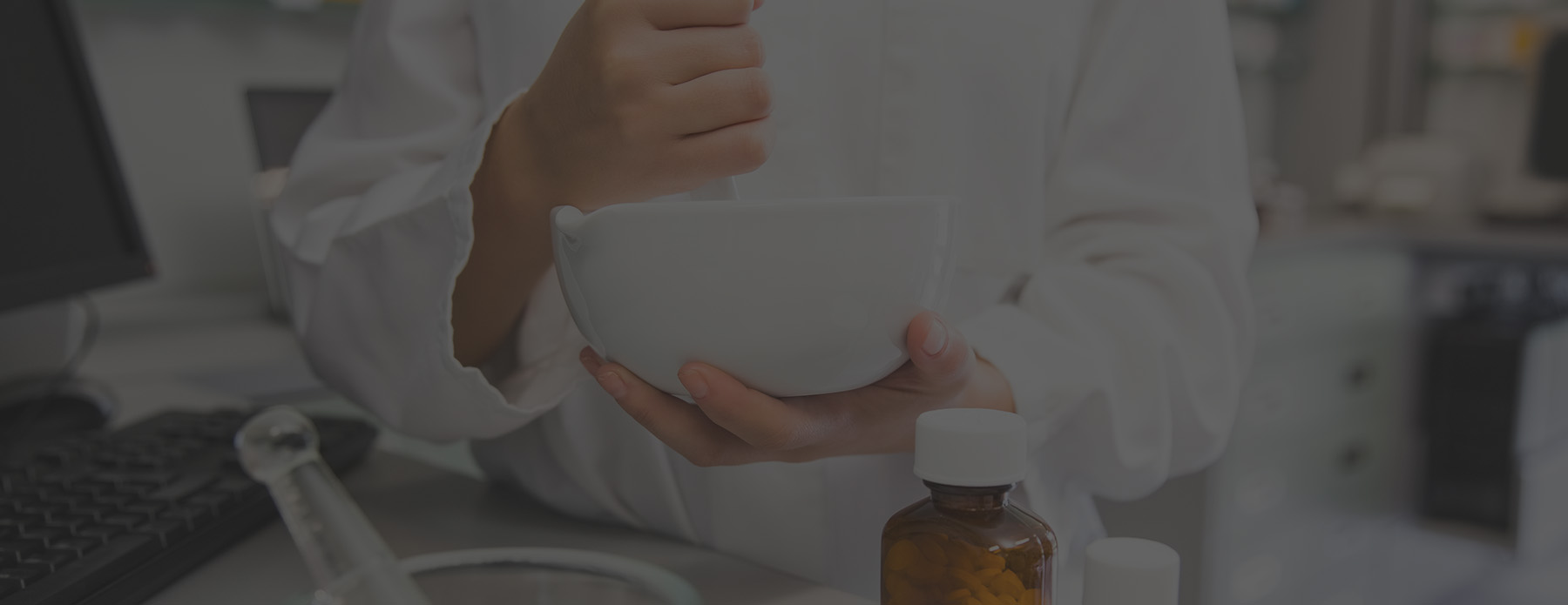 pharmacy student in lab coat with mortar and pestle