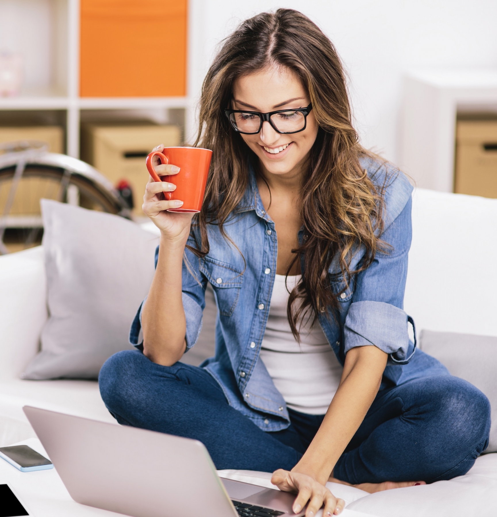 student looking at computer with cup of coffee