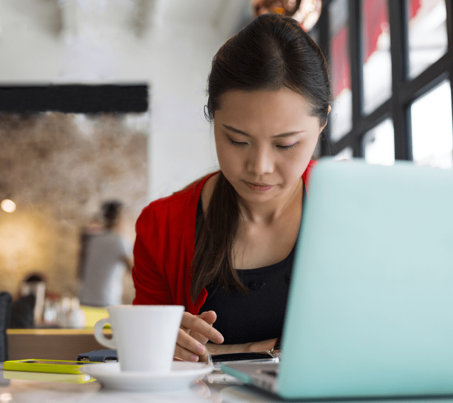 concerned woman studying ipad and phone
