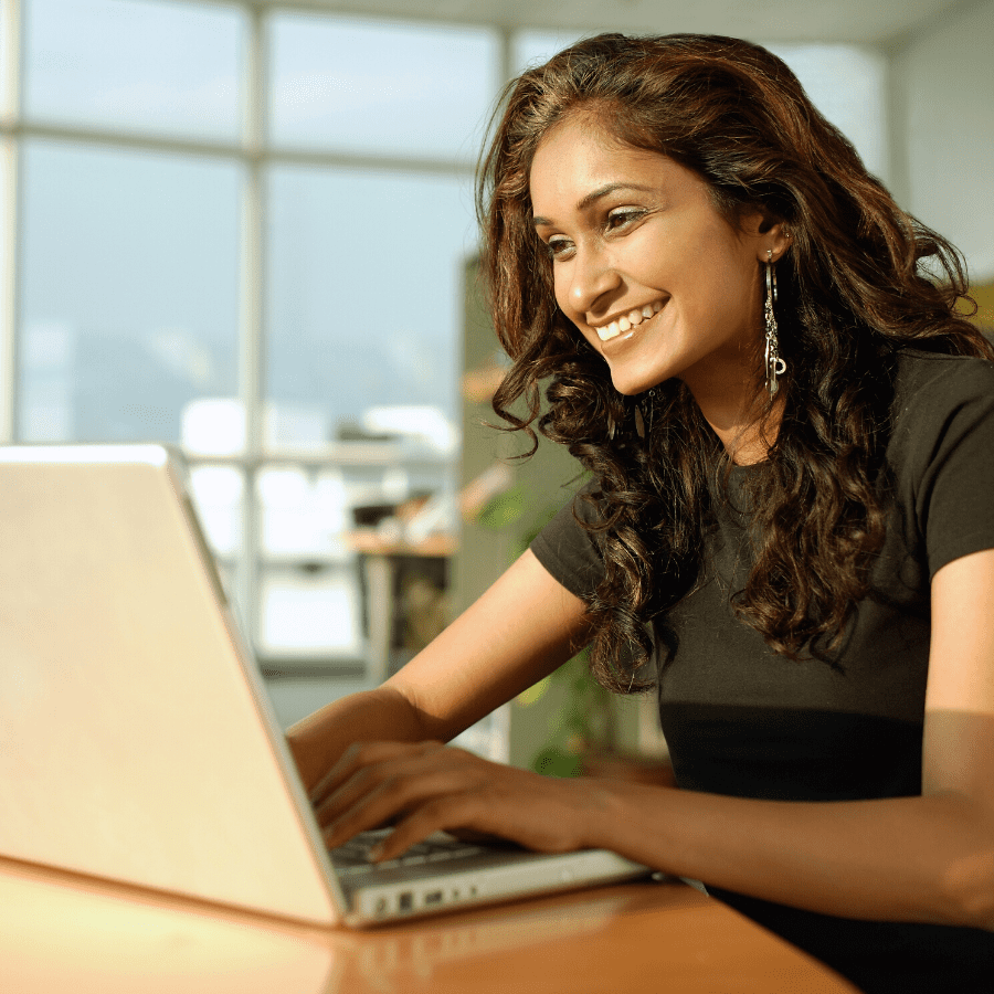 smiling woman looking at laptop computer