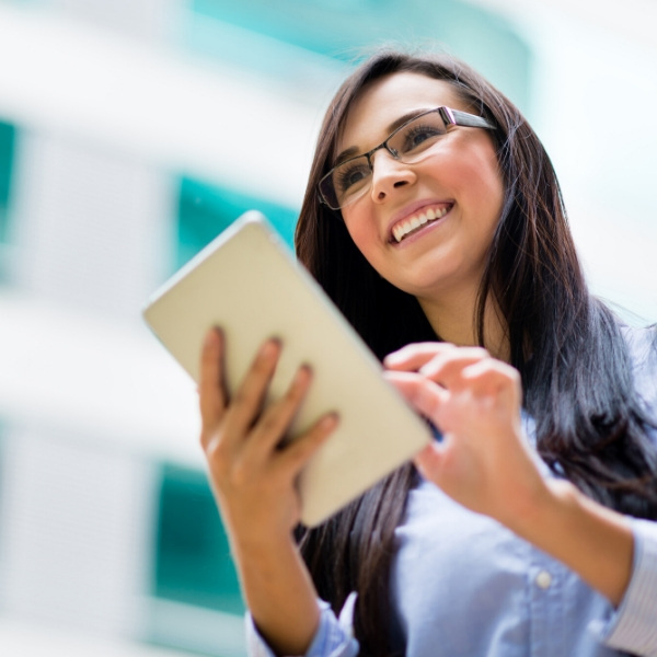 Asian woman looking at laptop smiling